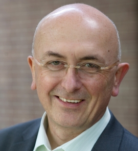 Ein Portraitfoto von Jean Paul Muller. Der 67-Jährige hat kaum Haare, eine Brille mit Goldrand und ein freundliches Lächeln.