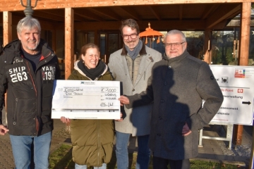 Jochen Knoesel (links) und Dr. Ulrich Ronge (2. von rechts) übergeben den Spendenscheck an Barbara Stehmann und Andreas Halbig vom Caritas- Don Bosco Bildungszentrum.