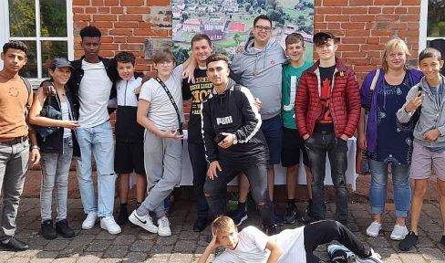 Gruppenbild Jugendliche mit Salesianer vor Backsteingebäude